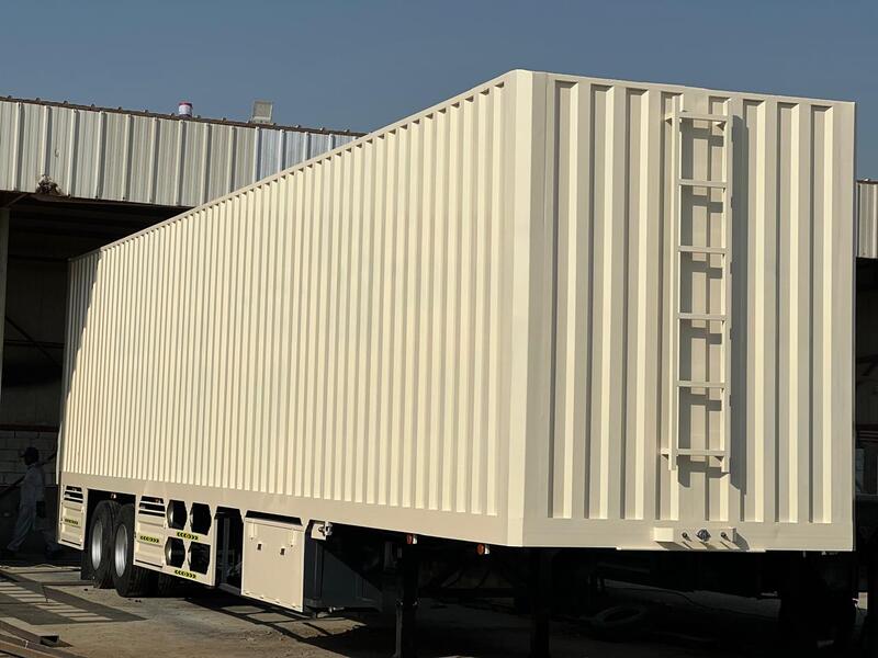 "box trailer beside flatbed trailer in Dubai"